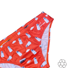 Load image into Gallery viewer, Salty Johnson sustainable mens swim briefs in red with white bottle pattern and logo detail