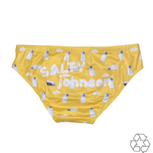 Load image into Gallery viewer, Salty Johnson sustainable mens swim briefs in yellow with white bottle print and logo design