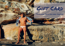 Load image into Gallery viewer, Salty Johnson AU sustainable swimwear gift card featuring a man in swim briefs by rocky beach background