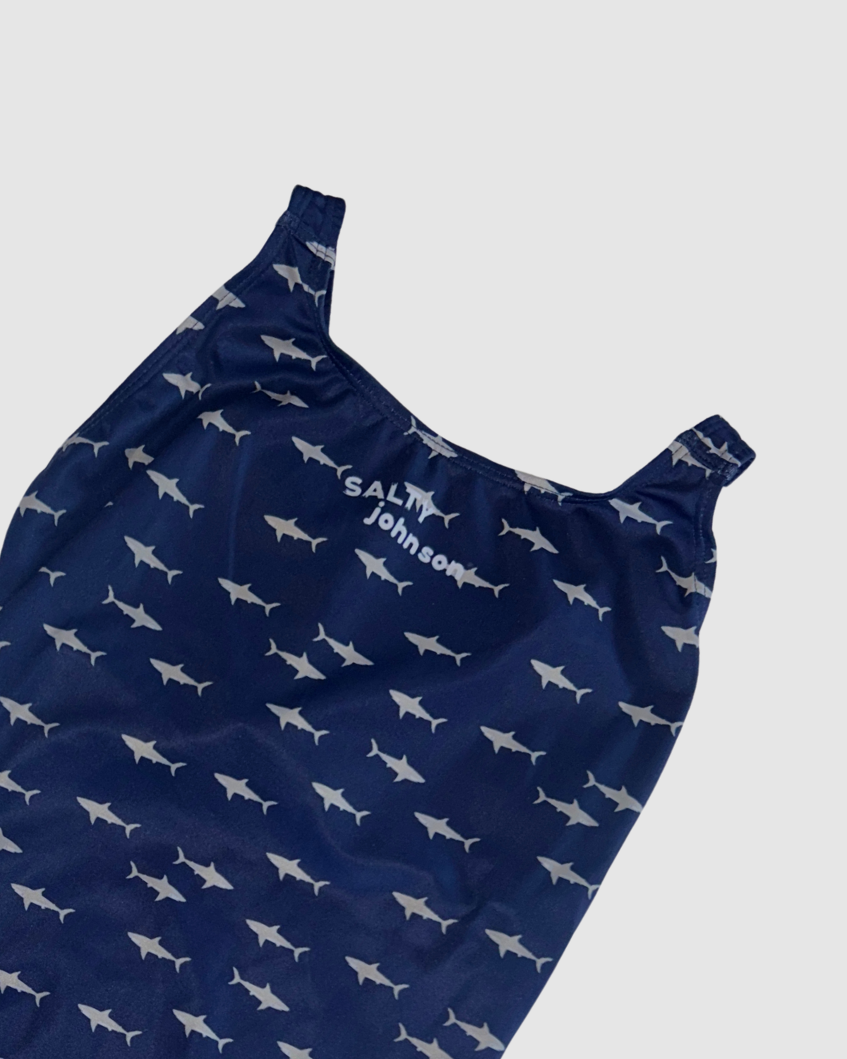 Neckline and print detail of White Pointer women's thick strap one-piece swimsuit, grey sharks on navy.