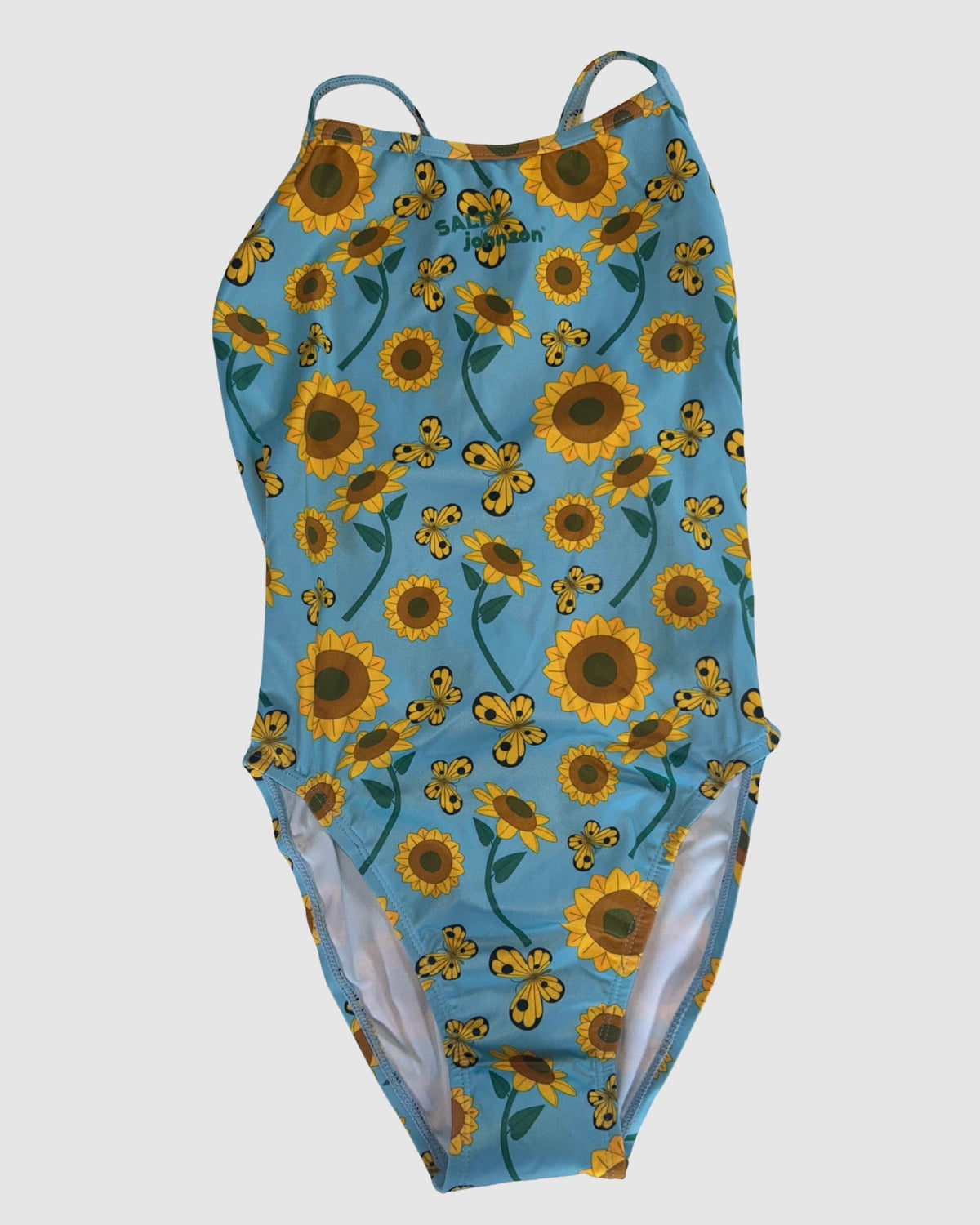 Front view of Sunny Side Up women's thin strap one-piece swimsuit, yellow sunflowers on light blue.