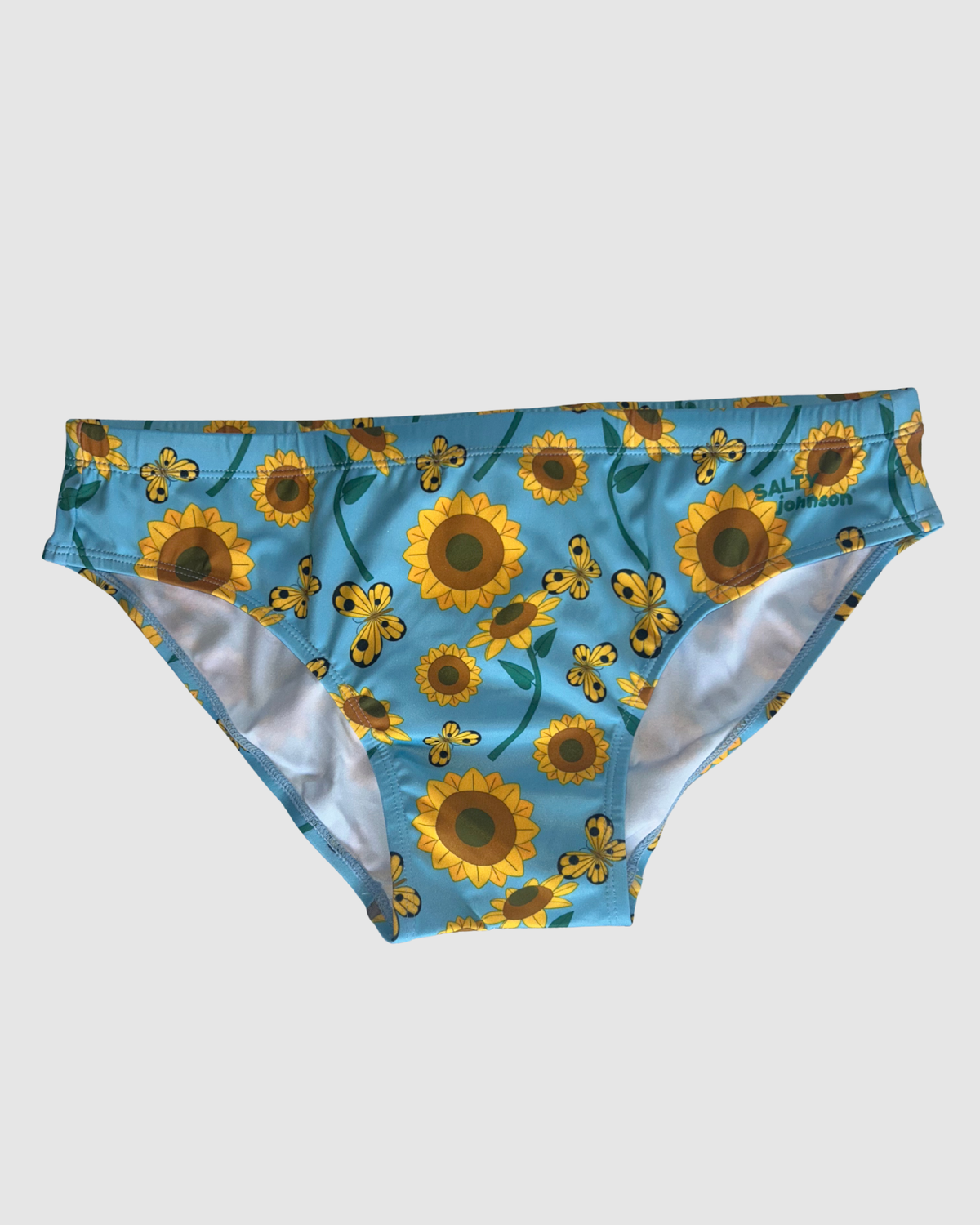 Front view of Salty Johnson Sunny Side Up men's swim briefs in blue, yellow, green.