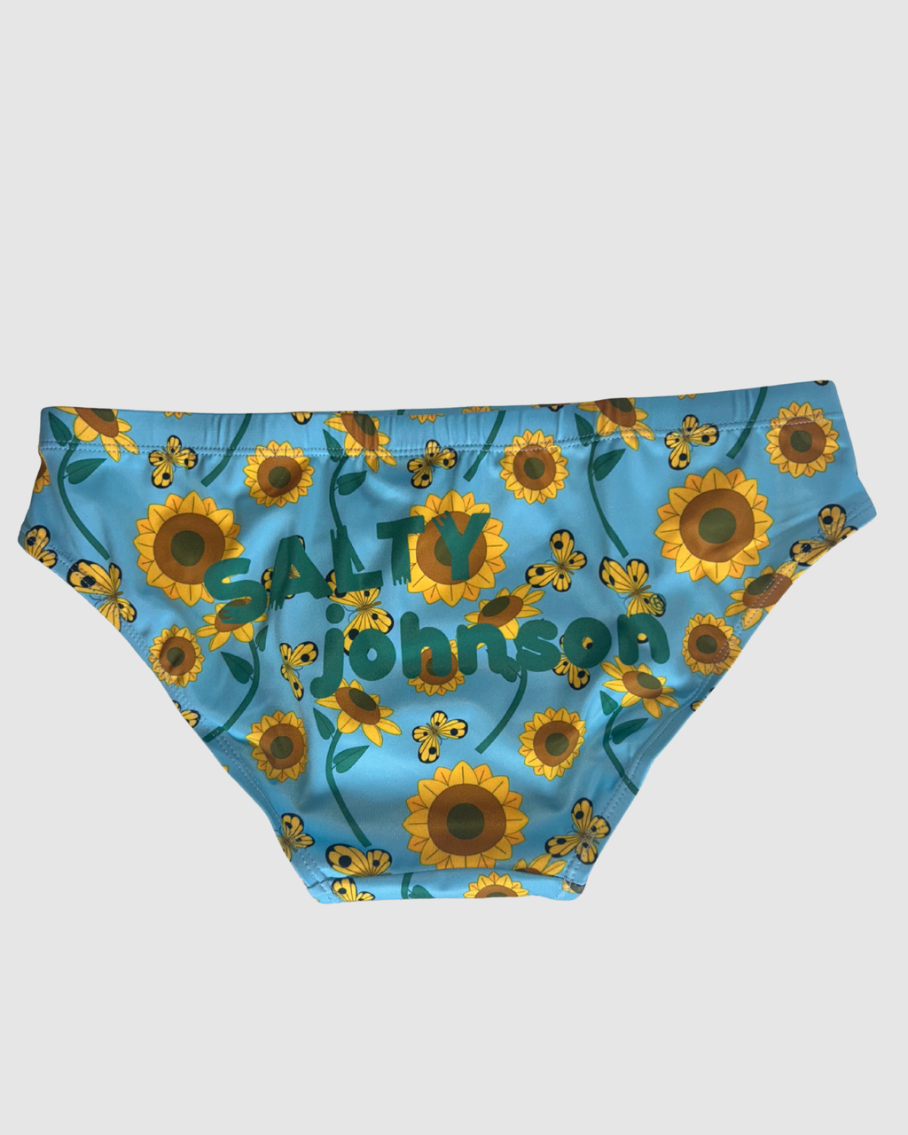 Back view of Salty Johnson Sunny Side Up men's swim briefs in blue, yellow, green.