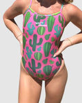 Front view of Salty Johnson Prickly Business Pink women's thin strap one piece swimsuit in pink, green.