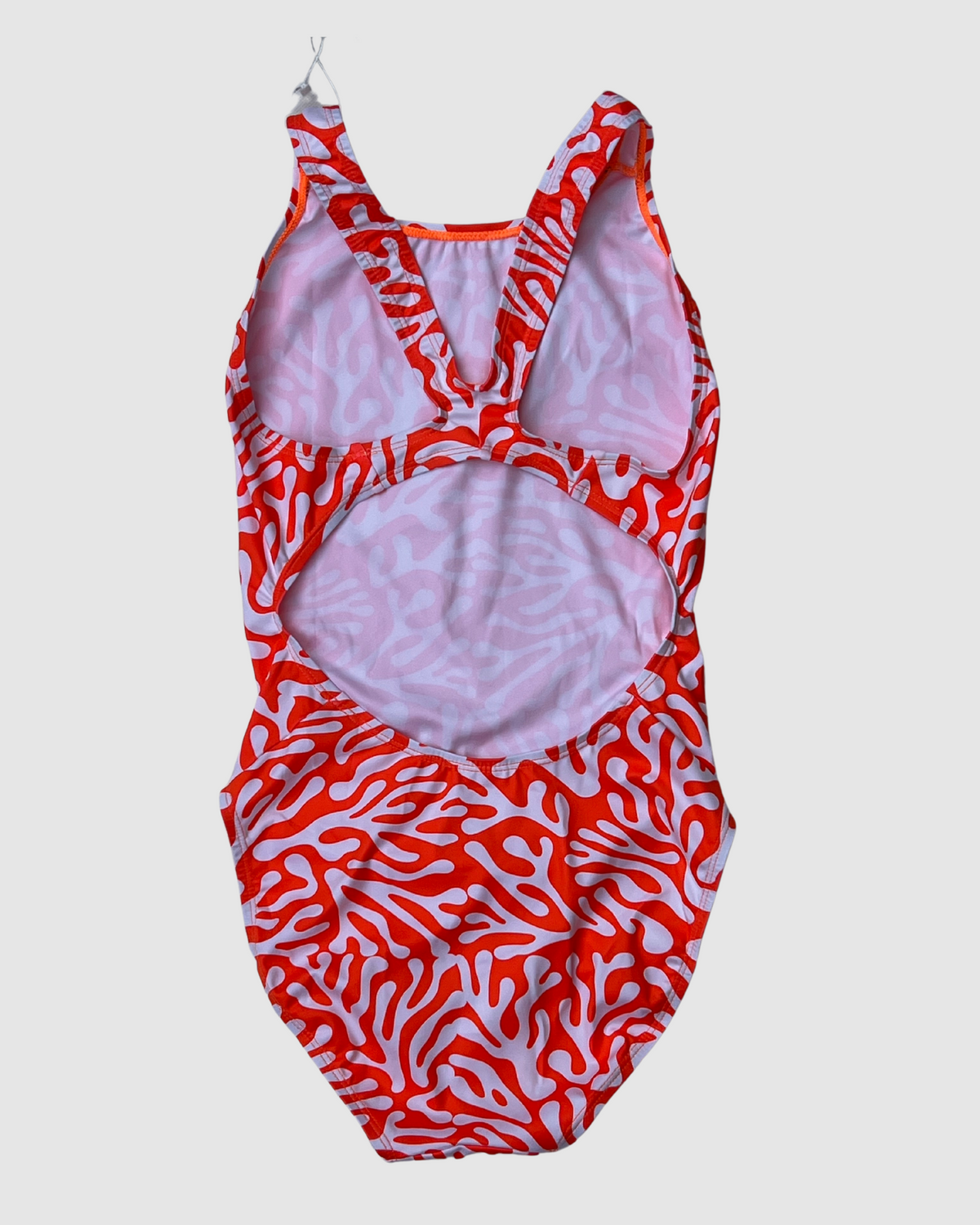 Sustainable womens Coral one piece swimsuit with a vibrant coral design and open back for comfortable beachwear