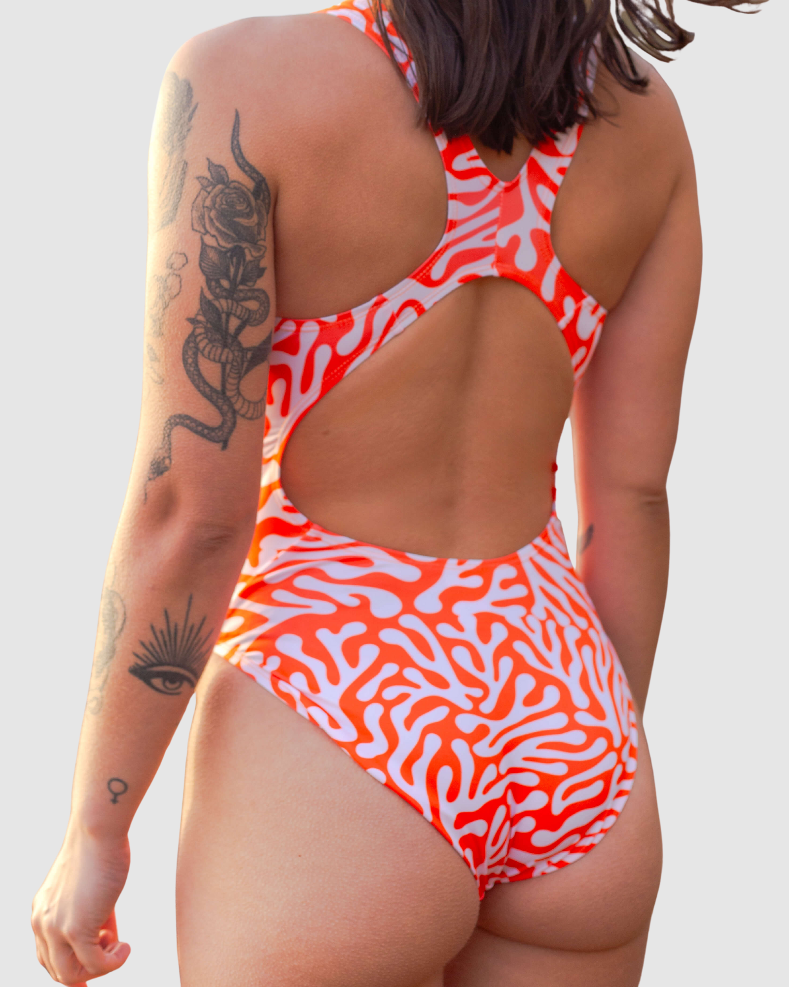Salty Johnson AU sustainable womens one piece swimsuit with a vibrant orange coral design and open back